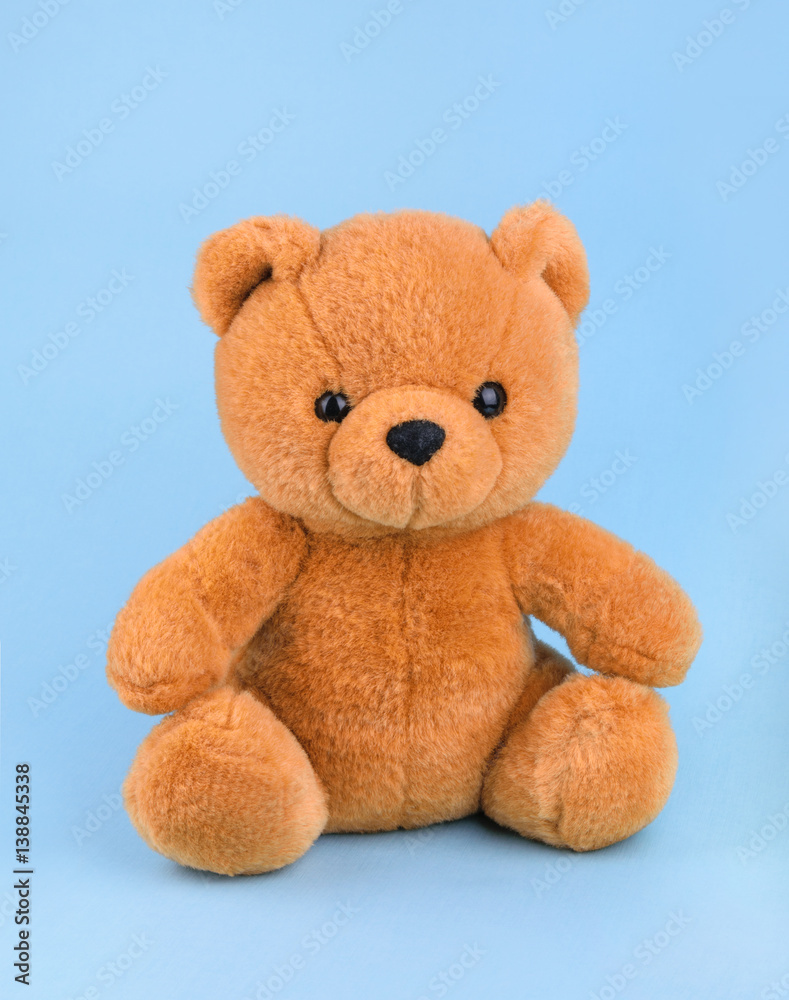 Toy teddy bear on blue background