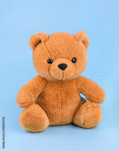 Toy teddy bear on blue background