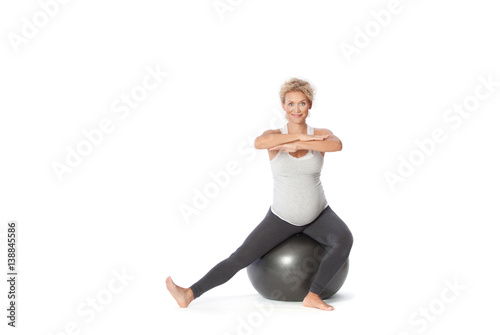 Pregnant woman exercise, sitting position on pilates ball