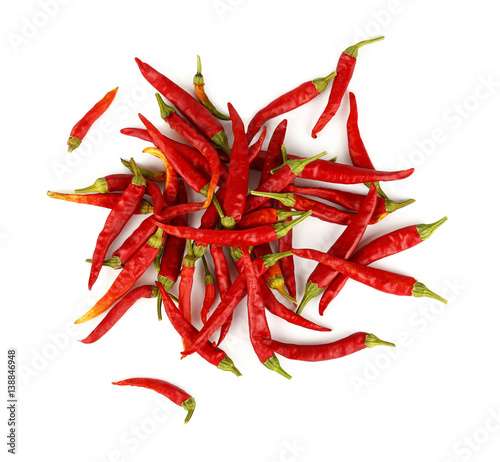 Heap of red hot chili peppers isolated on white