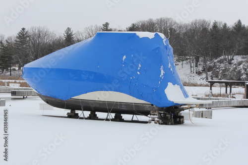 Blue shrink wrap on boats covered in during the winter season as protection against elements.