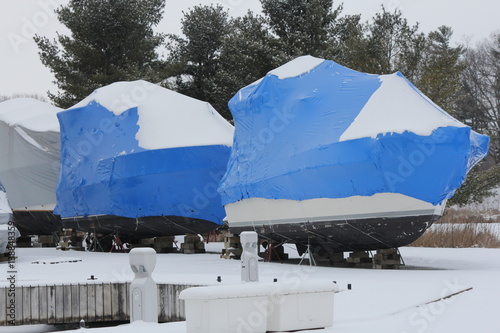 Blue shrink wrap on boats covered in during the winter season as protection against elements.