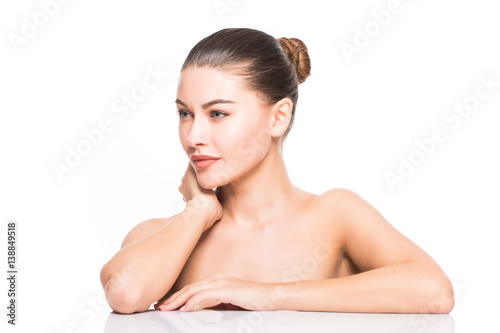 Beauty Portrait. Beautiful Spa Woman Touching her Face. Perfect Fresh Skin. Isolated on White Background. Pure Beauty Model.