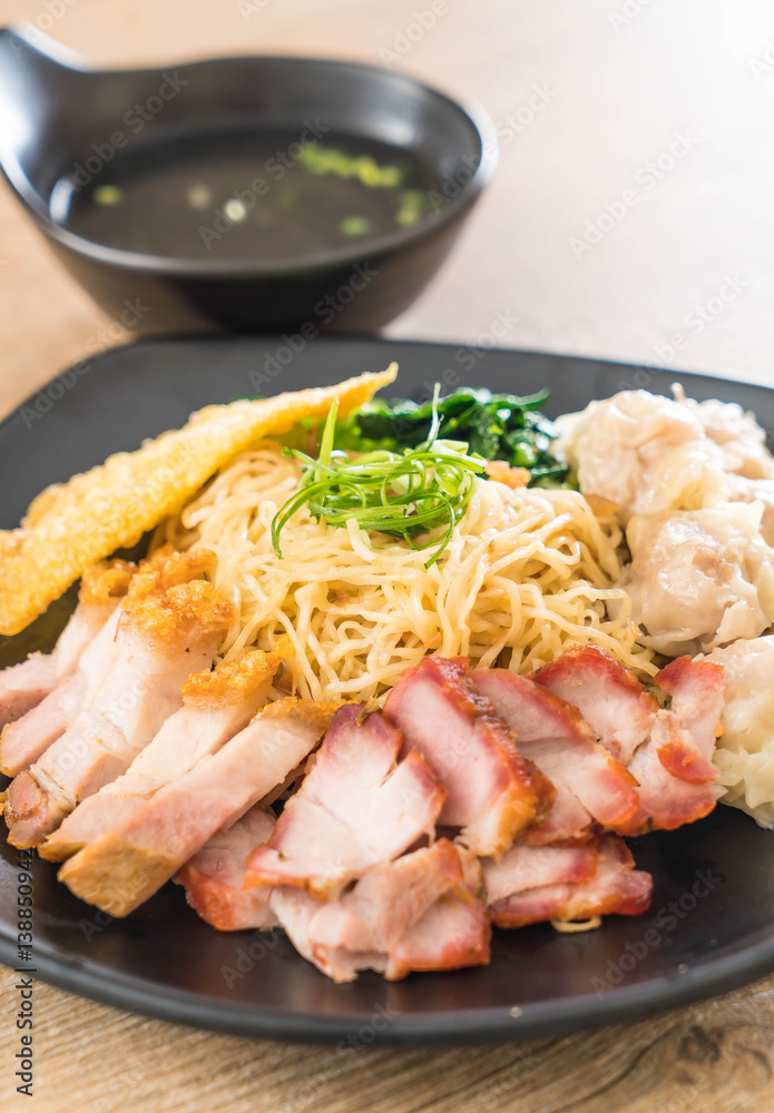 Egg noodle with red roast pork, crispy pork, dumplings and soup Egg noodle with red roast pork, crispy pork, dumplings and soup