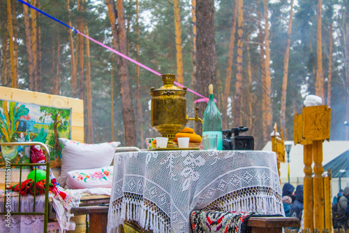 Samovar and blue bottle on the white table