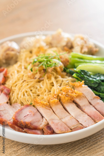 Egg noodle with red roast pork, crispy pork, dumplings and soup