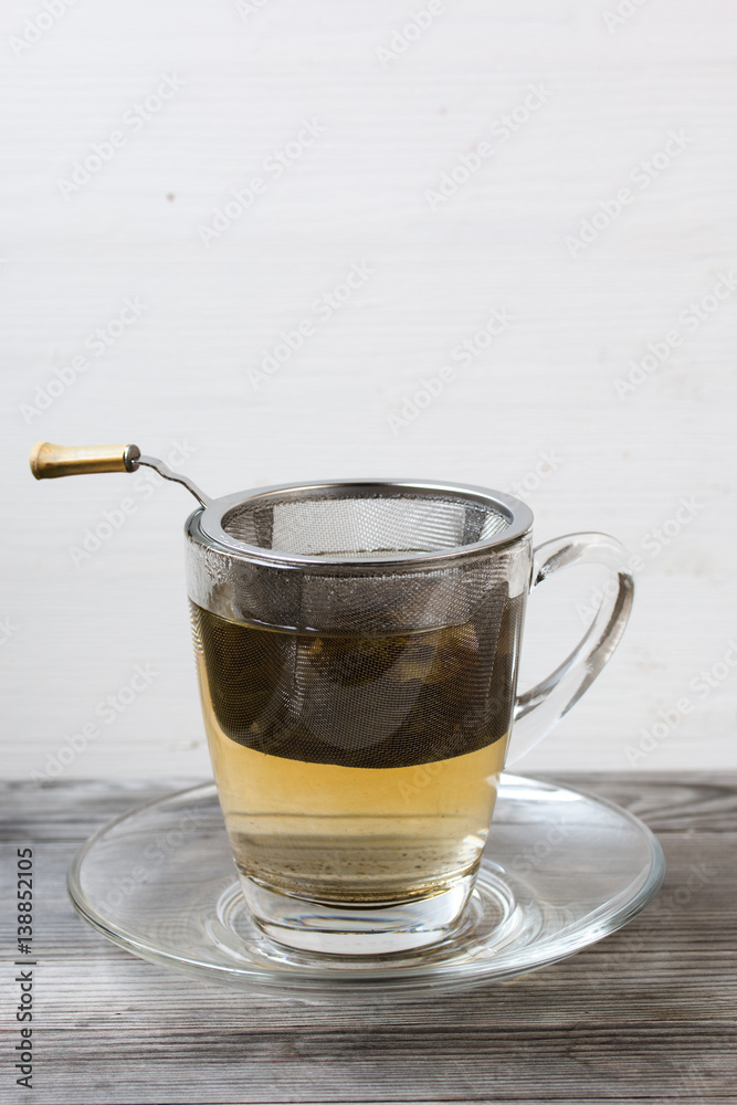 Green tea. Strainer. Grey wooden background. Copy space