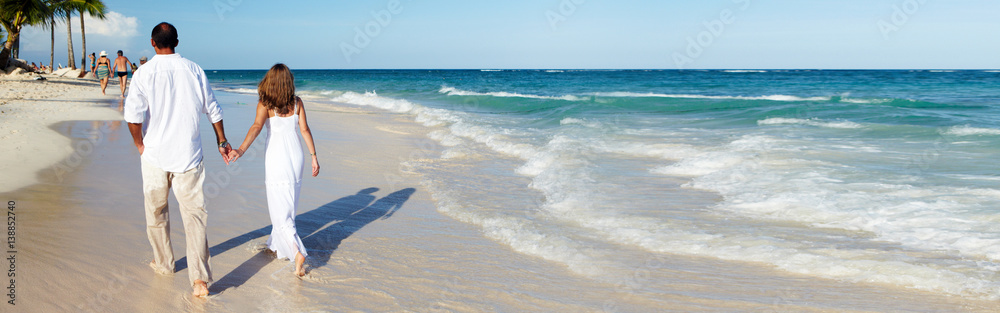 Couple walking on the beach Couple walking on the beach