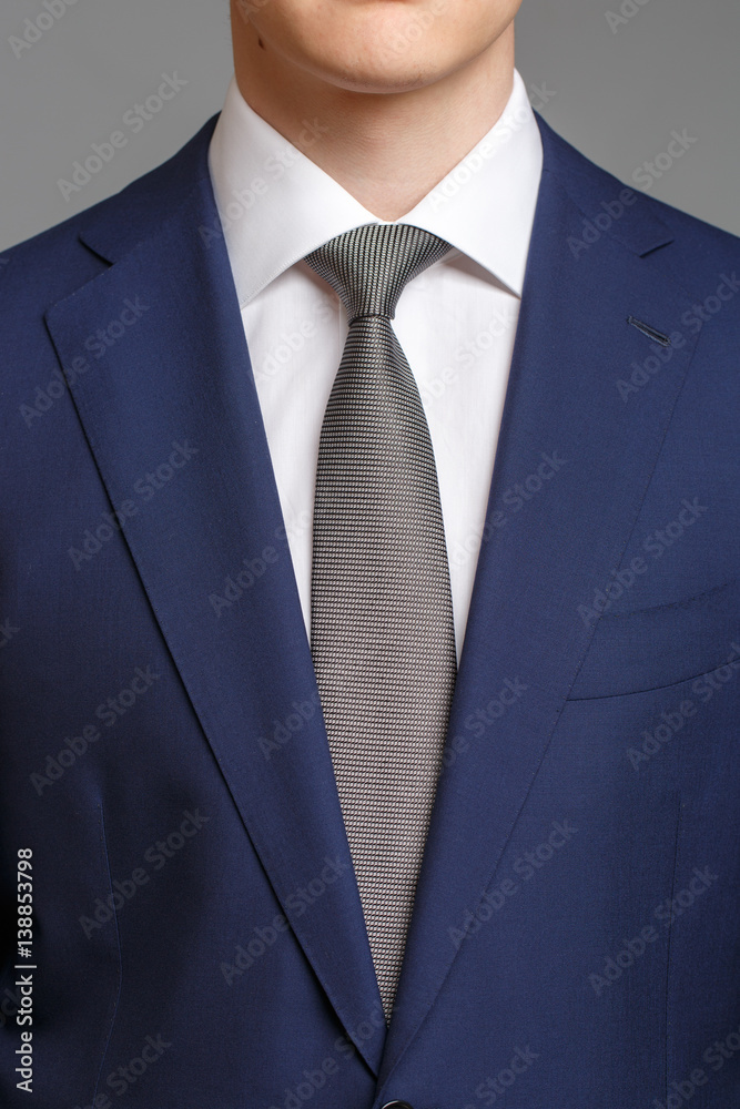 man in blue tuxedo with grey tie man in blue tuxedo with grey tie