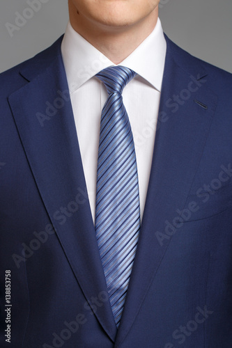 man in blue tuxedo with light blue tie