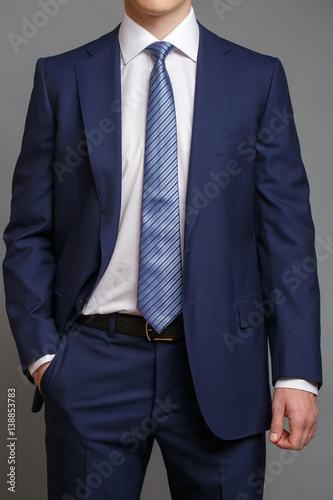 man in blue tuxedo with light blue tie