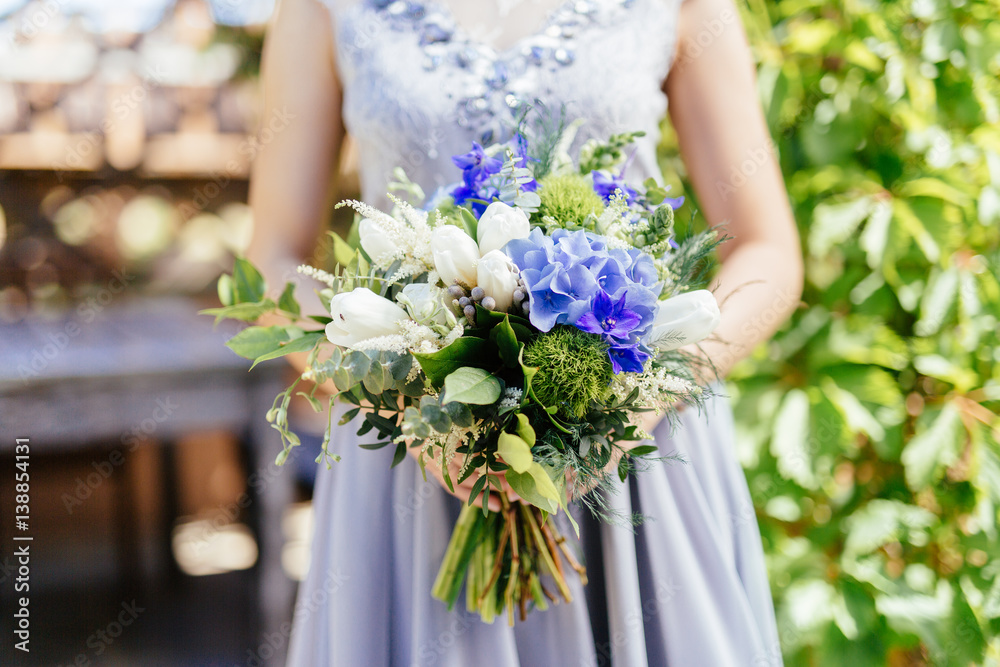 woman holding on to flower bouquet woman holding on to flower bouquet