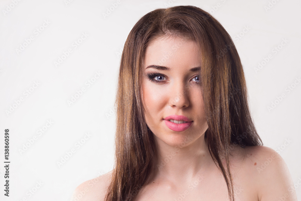 Portrait of a brunette on a light background. Portrait of a brunette on a light background.