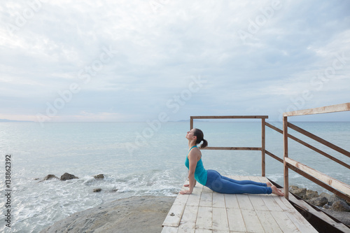Young yoga woman in yoga pattern exercise for healthy life. Woman yoga concept. © Artur Nyk