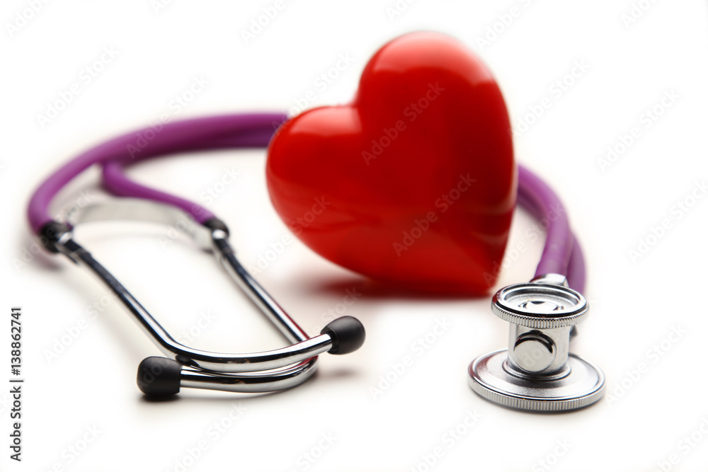 Heart with a stethoscope, isolated on wooden background Heart with a stethoscope, isolated on wooden background