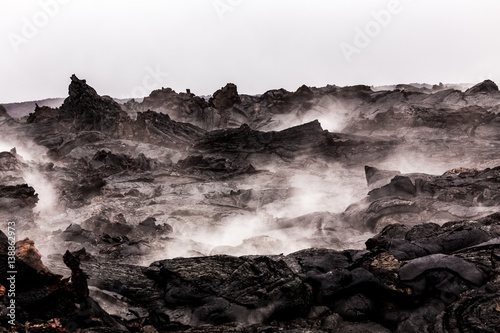 Canvas Print Steaming lava pieces under light rain
