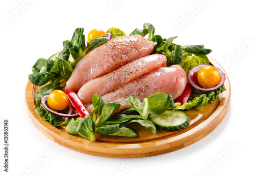 Raw chicken breasts on cutting board 