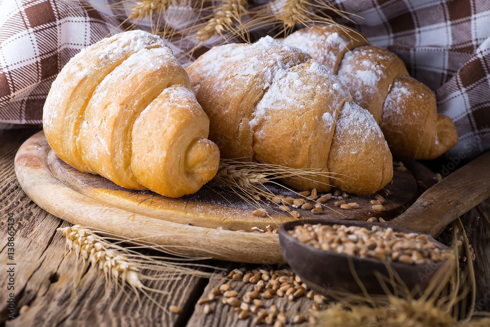 delicious fresh croissants on a wooden background