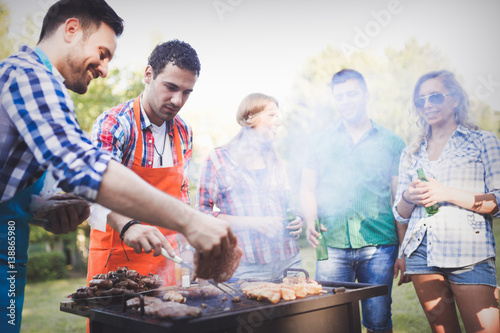 Friends having a barbecue party in nature