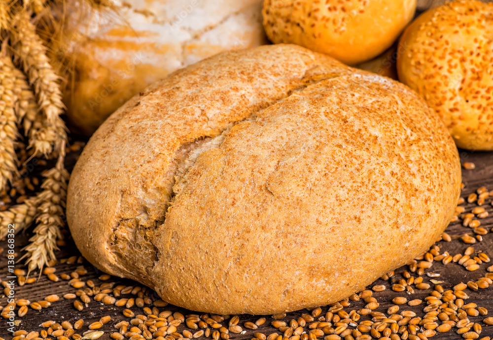 Assortment of baked bread on wooden table background Assortment of baked bread on wooden table background