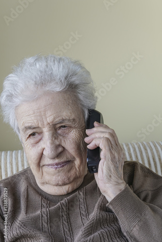 Thoughtful senior woman on phone