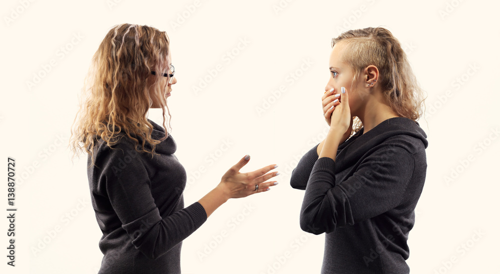 Self talk concept. Young woman talking to herself, showing gestures. Double portrait from two different side views.