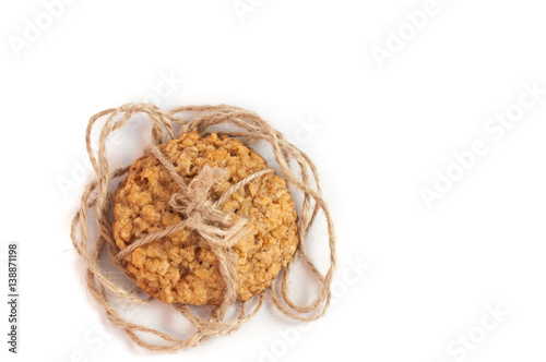 homemade nut oat cookies tied up with brown rope, on isolated white background