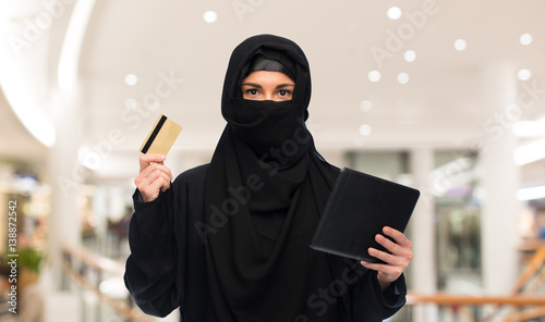 woman in hijab with tablet pc and credit card