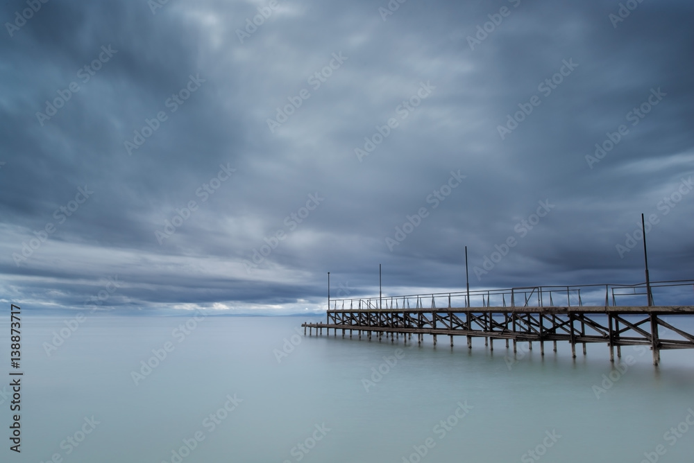 Dramatic cloudy sky with sea bridge in Ravda, Bulgaria. Slow motion effect.