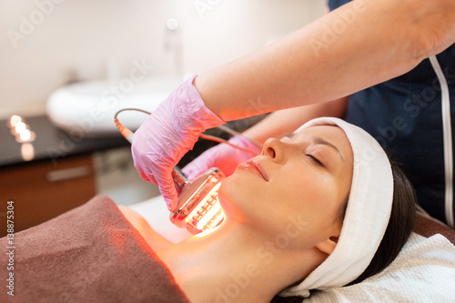 young woman having face microdermabrasion at spa
