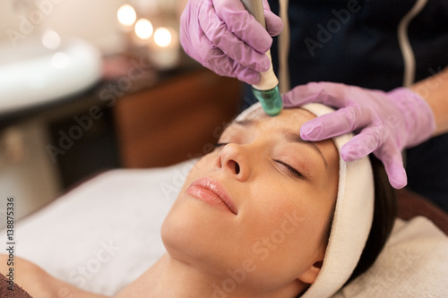 woman having microdermabrasion facial treatment photo