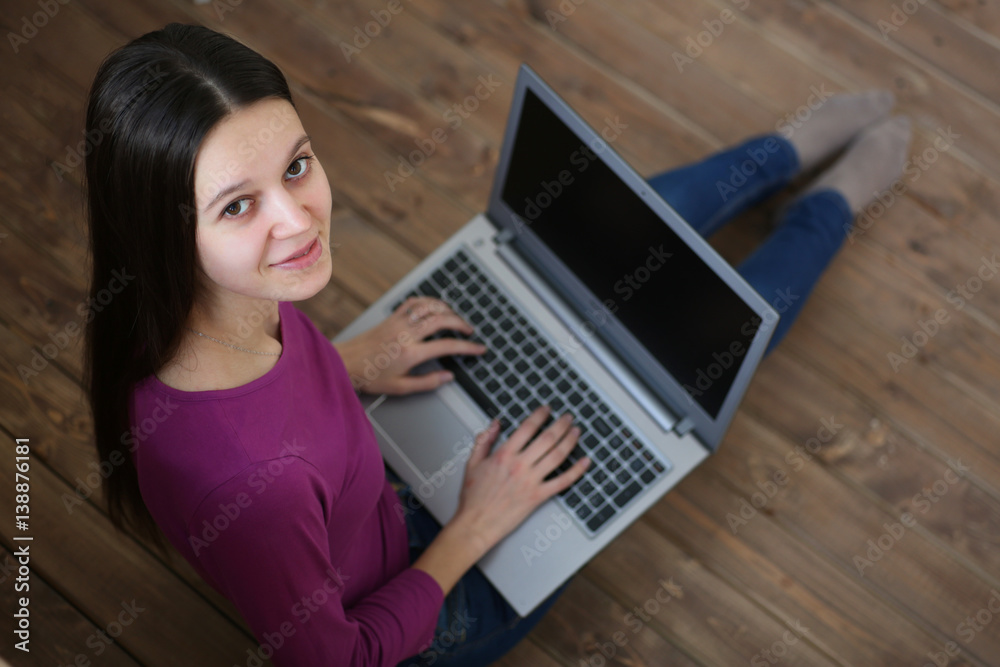 Female student sitting on the floor with a laptop and learn Female student sitting on the floor with a laptop and learn