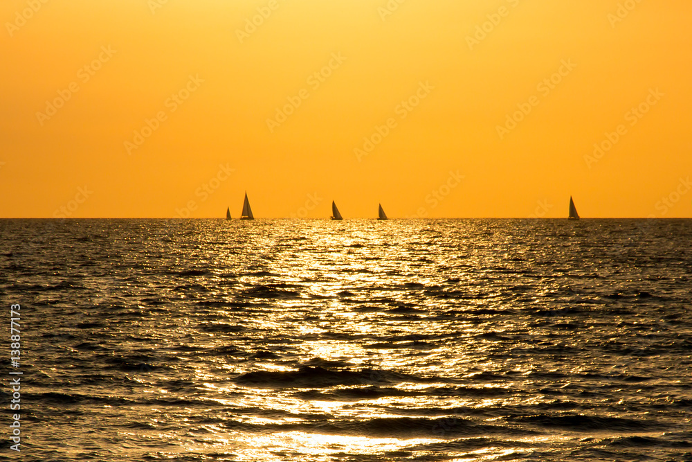 Sunset on Atlantic ocean with the boats on the horizon