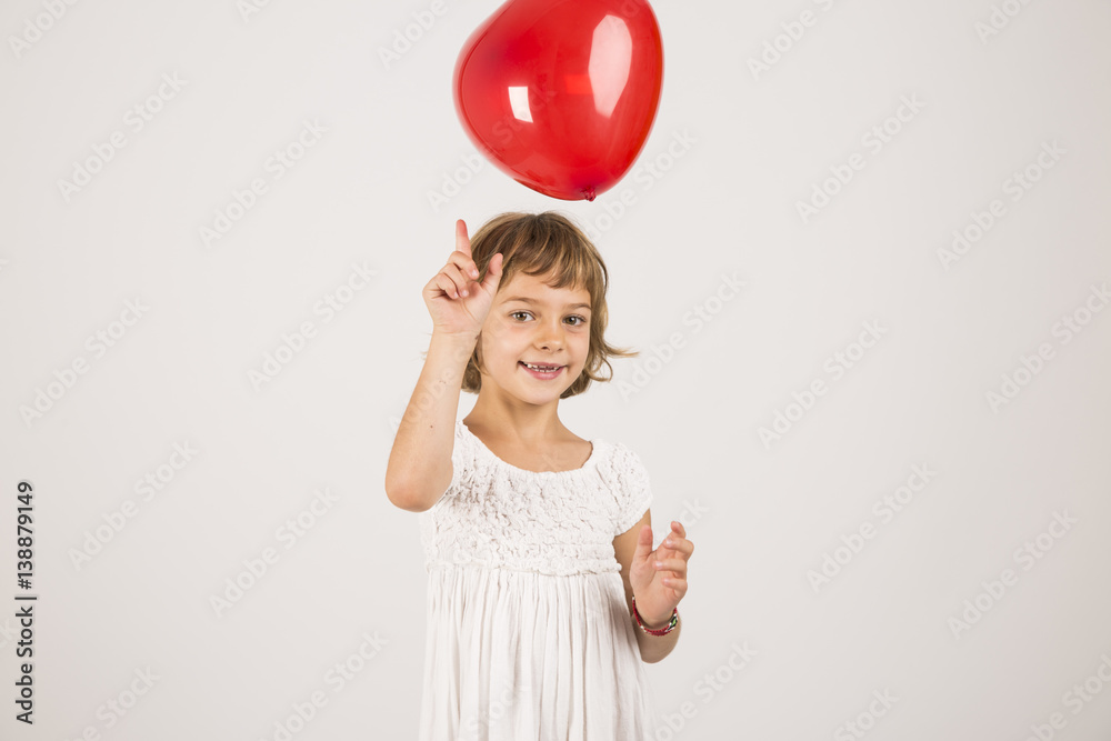 kid playing with a red balloon in the studio. Fun, lifestyle. white background kid playing with a red balloon in the studio. Fun, lifestyle. white background