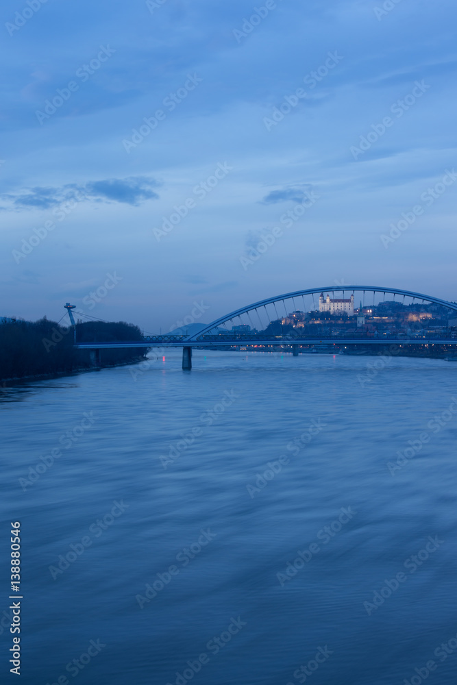 Old town, riverside, Bratislava castle, Apollo Bridge, UFO Bridge, New Bridge shoot during dusk from above river Danube, Slovakia