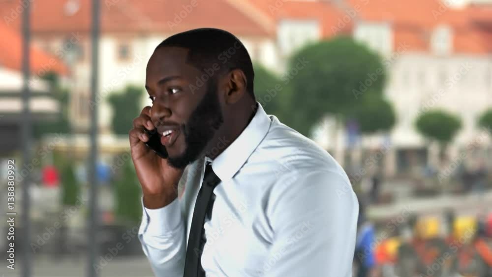 Male with phone raising fist. Black man on street background. Right decisions lead to success. Male with phone raising fist. Black man on street background. Right decisions lead to success.