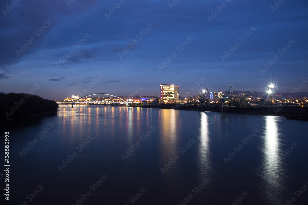 Old town, riverside, Bratislava castle, Apollo Bridge, UFO Bridge, New Bridge shoot during dusk from above river Danube, Slovakia