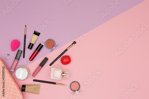 makeup cosmetics and brushes on color background