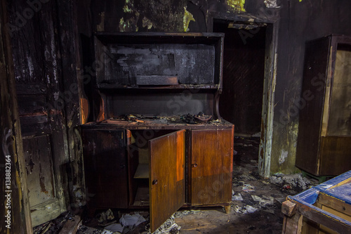 Interior of the burned by fire house, burned furniture