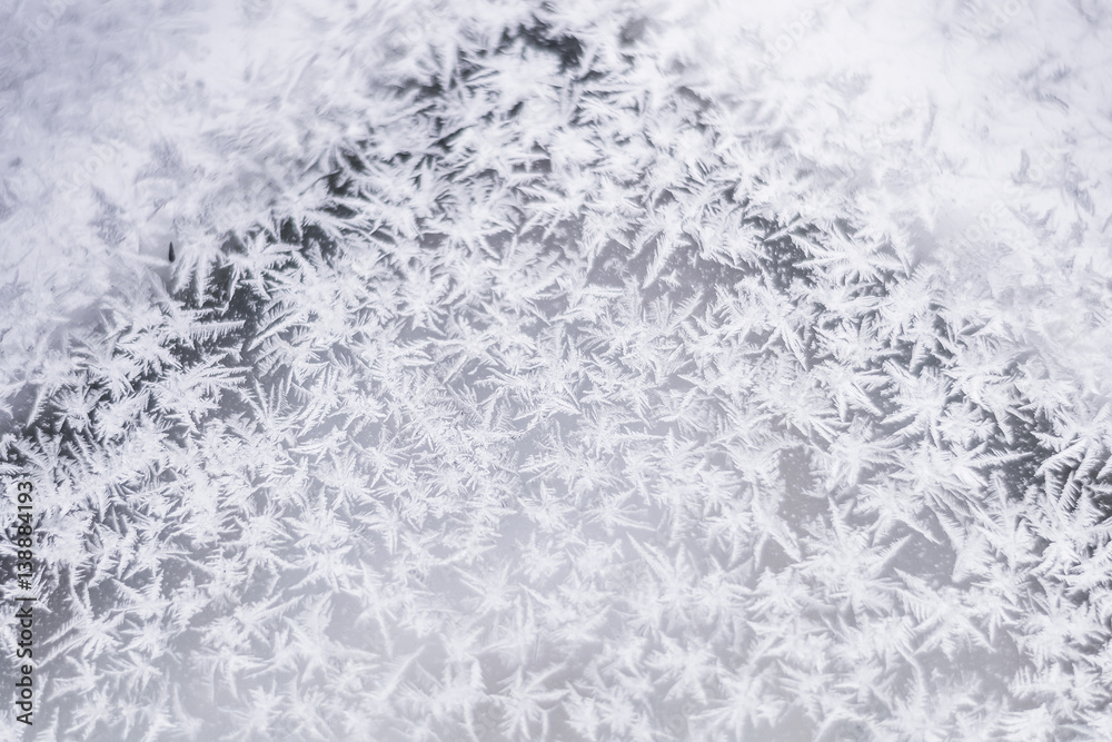 Fototapeta premium Beautiful winter background in the form of snowflakes, frost, ice crystals.