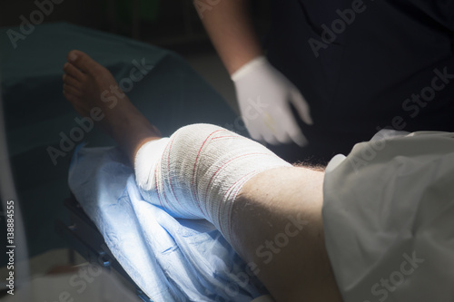 Knee surgery nurse bandaging