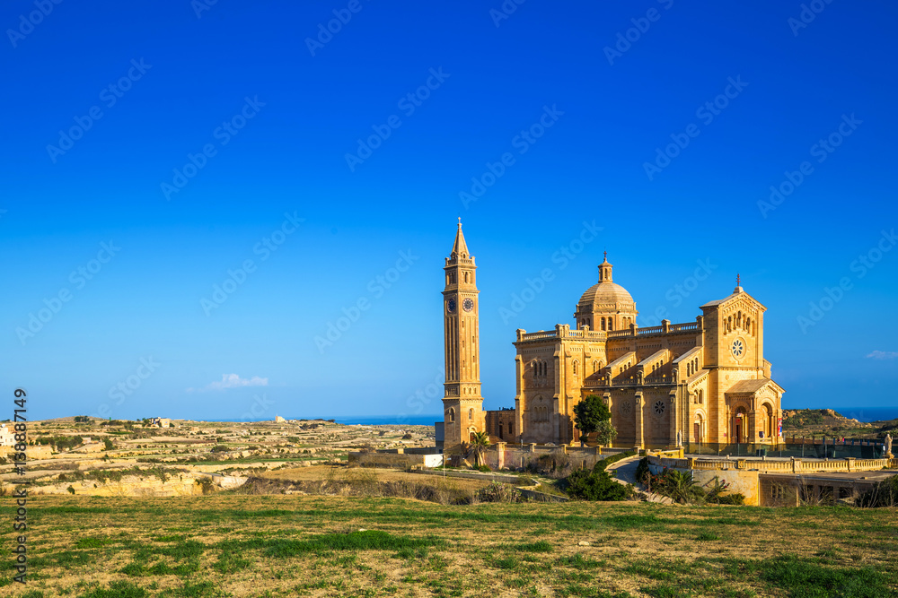 Gozo, Malta - The Basilica of the National Shrine of the Blessed Virgin of Ta' Pinu early at the morning with clear blue sky on a summer day