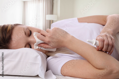 Woman sneezing and holding tissue  flu symptoms. Healthcare and medical concept
