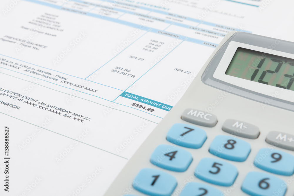 Unpaid utility bill and calculator next to it Unpaid utility bill and calculator next to it