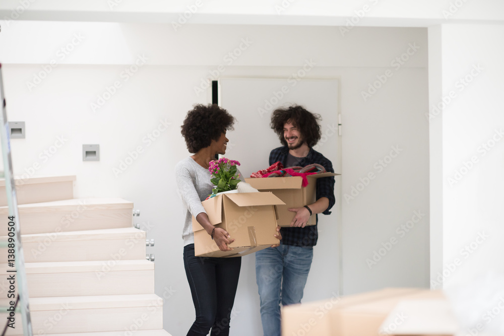 multiethnic couple moving into a new home multiethnic couple moving into a new home