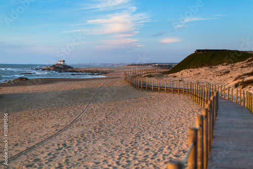 Wooden fence on sand dunes at Miramar beach on the Atlantic coast of Portugal.