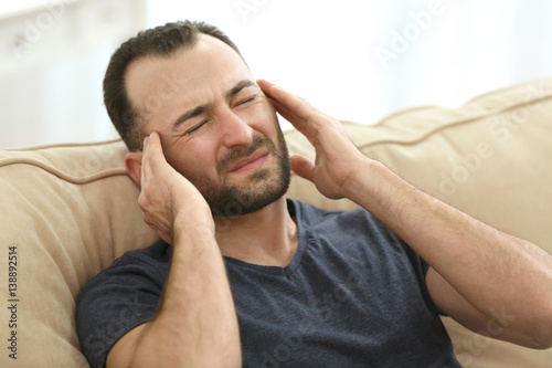 Handsome man suffering from...
