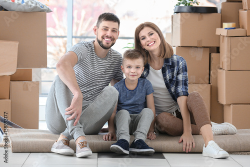 Young family sitting on the floor of new home