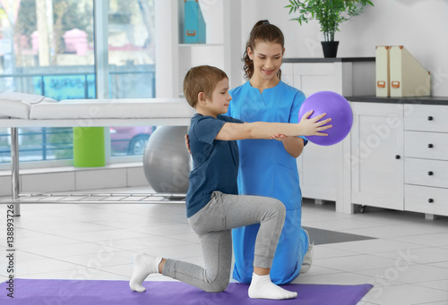 Physiotherapist working with patient in clinic