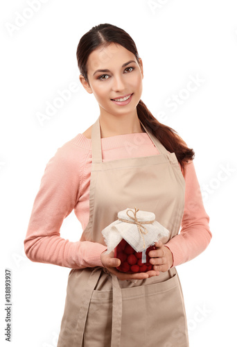 Young woman in apron holdin...